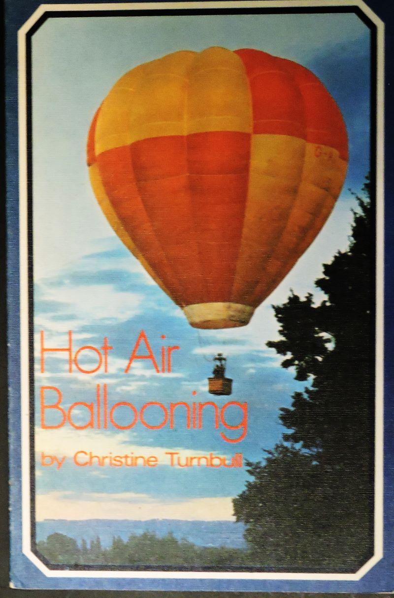 Picture of colour pictorial book cover showing a red and orange hot air balloon airborne passing some trees nearby.